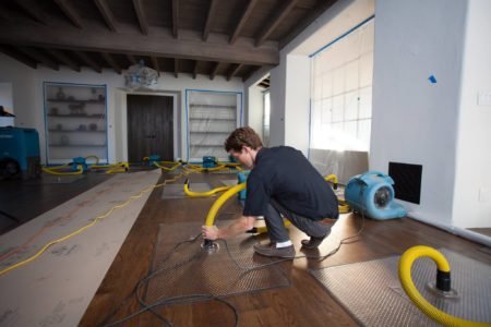 a man adds hardwood flooring to a home in Lethbridge, ab